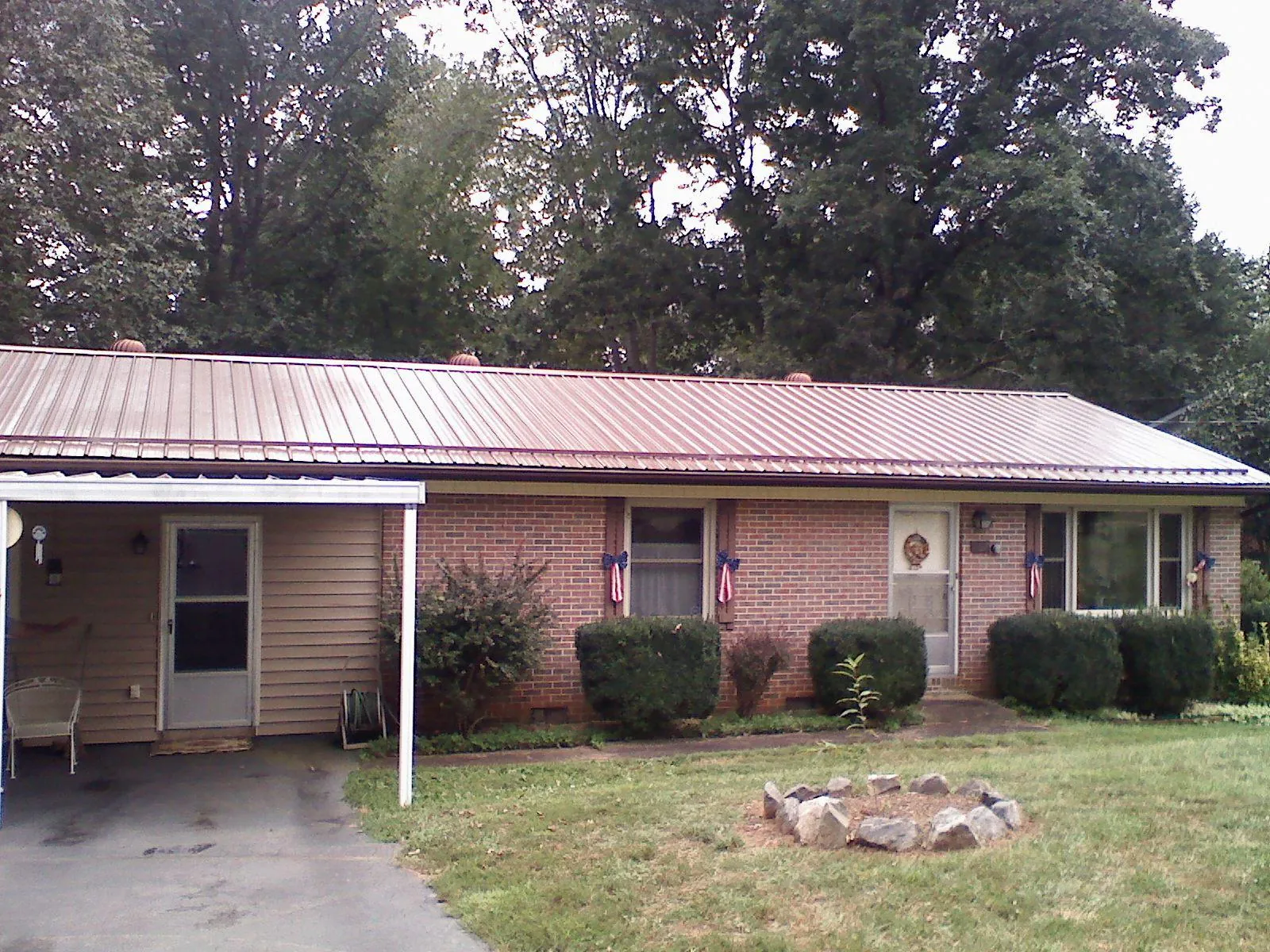 Bronze metal roof and carport on a brick ranch home — Roof Repair work by our crew in Mountain Dale