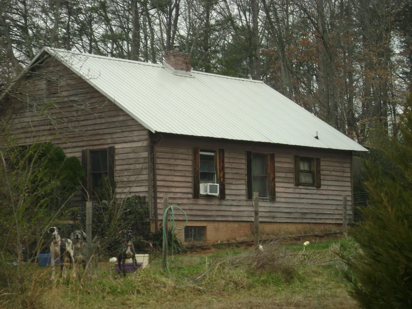 White metal roof on an old wood sided farmhouse, from a Metal Roof Installation job in Mountain Dale